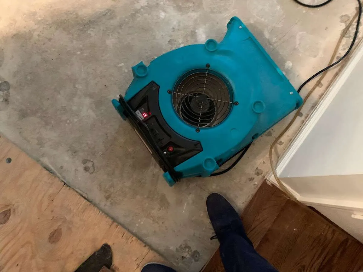 Air mover drying subfloor during Commercial Water Damage Restoration in Park City